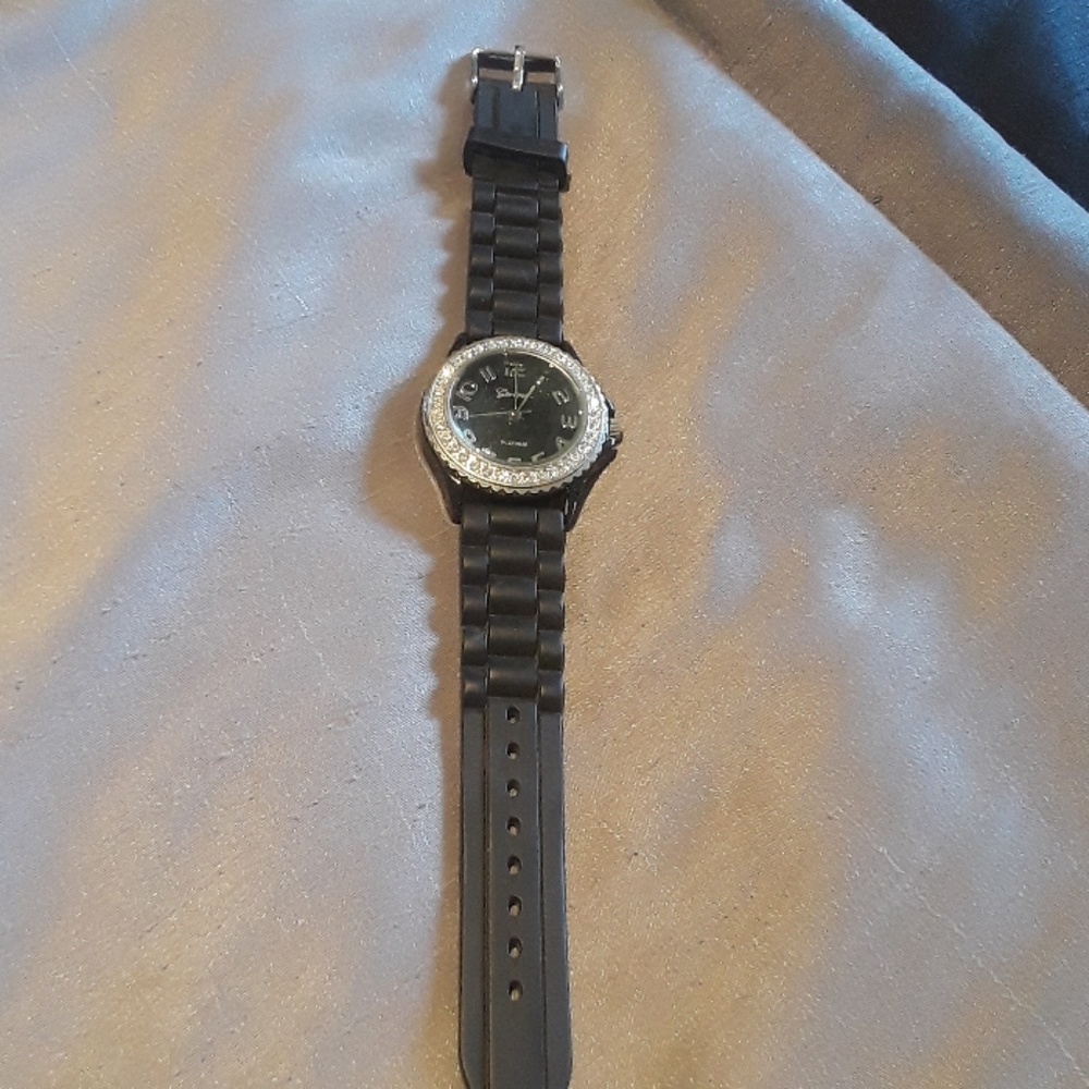 Black watch with crystals around the watch face